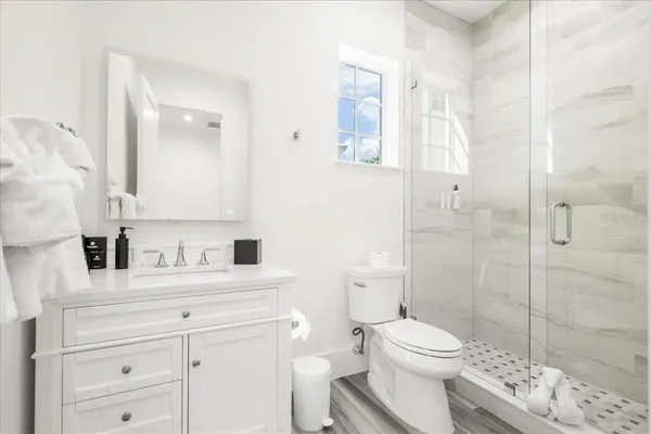 a bedroom with a bed a flat screen tv and dresser