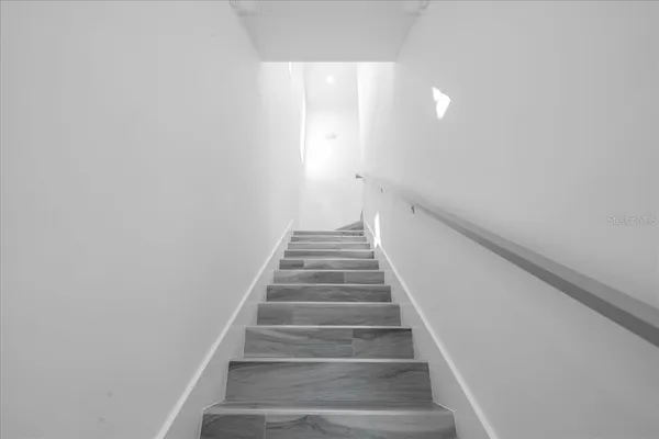 a white bath tub sitting in a bedroom next to a window