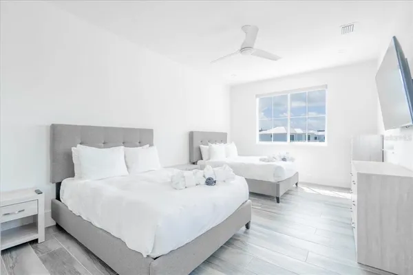 a bedroom with a bed and a flat screen tv