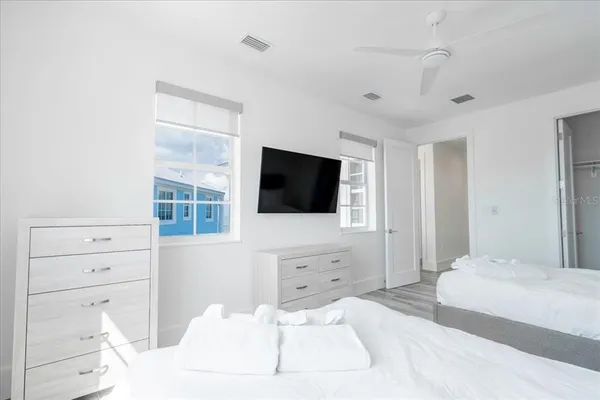 a bedroom with a bed and a flat screen tv