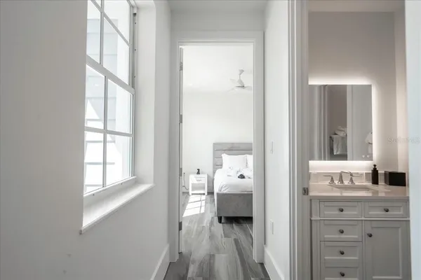 a white toilet sitting next to a white cabinet