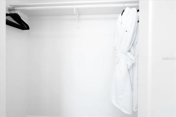 a balcony with furniture and a potted plant