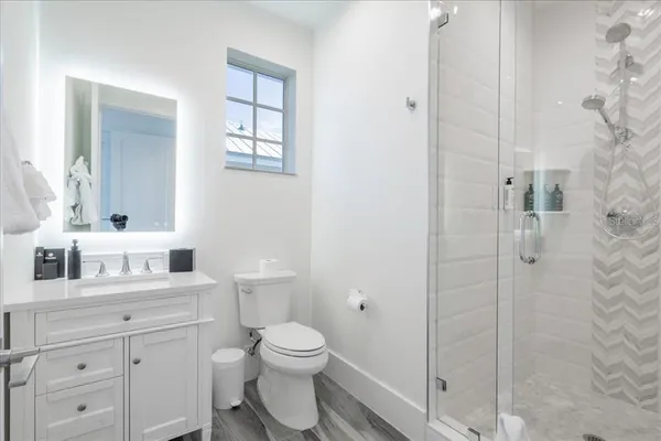 a large kitchen with stainless steel appliances granite countertop a large counter top a stove a sink and a refrigerator