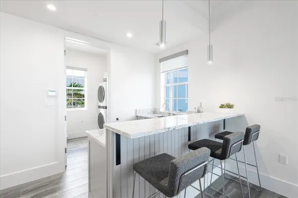 a bathroom with a granite countertop toilet and a sink