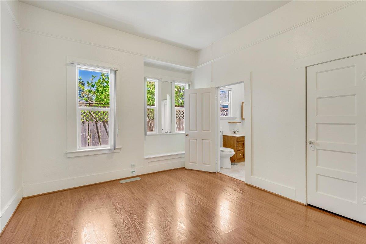 113 Fairbanks Street Santa Cruz, CA 95060 - Photo 15 of 27 an empty room with wooden floor and windows