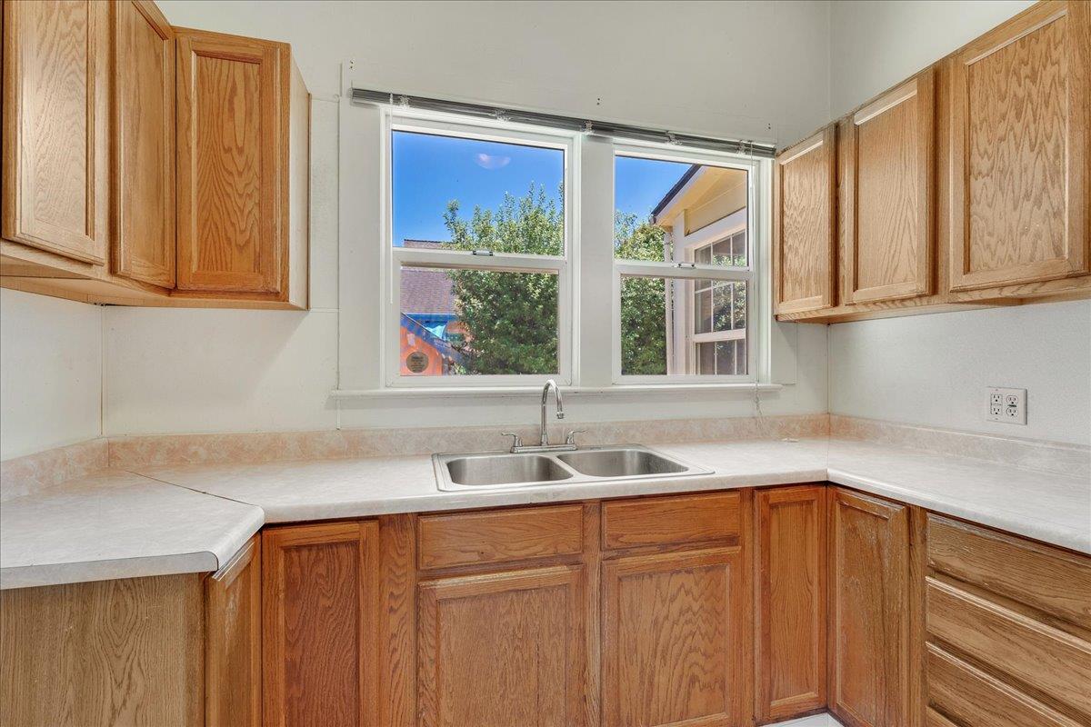 113 Fairbanks Street Santa Cruz, CA 95060 - Photo 21 of 27 a kitchen with stainless steel appliances granite countertop a sink and a window