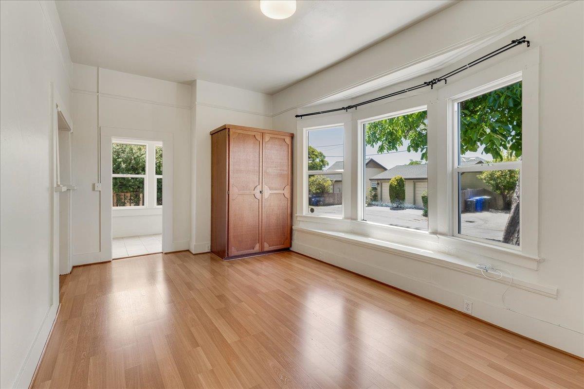 113 Fairbanks Street Santa Cruz, CA 95060 - Photo 5 of 27 an empty room with wooden floor and windows