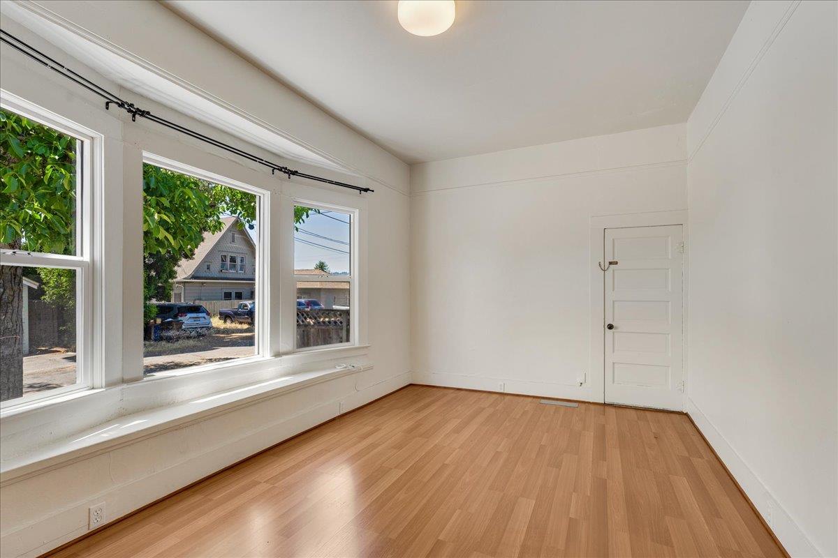 113 Fairbanks Street Santa Cruz, CA 95060 - Photo 7 of 27 a view of an empty room with wooden floor and a window