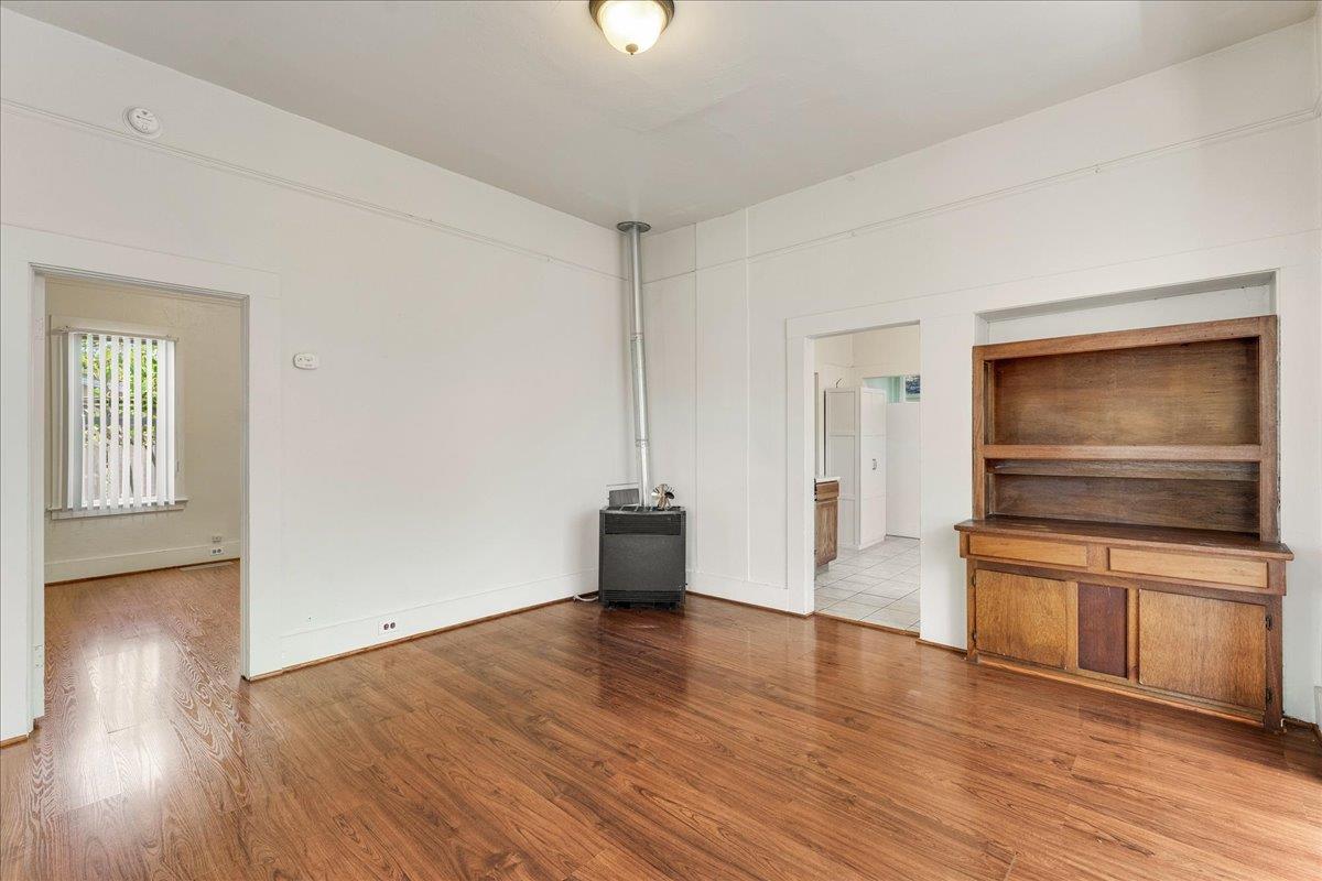 113 Fairbanks Street Santa Cruz, CA 95060 - Photo 8 of 27 a view of a kitchen and an empty room with wooden floor kitchen view
