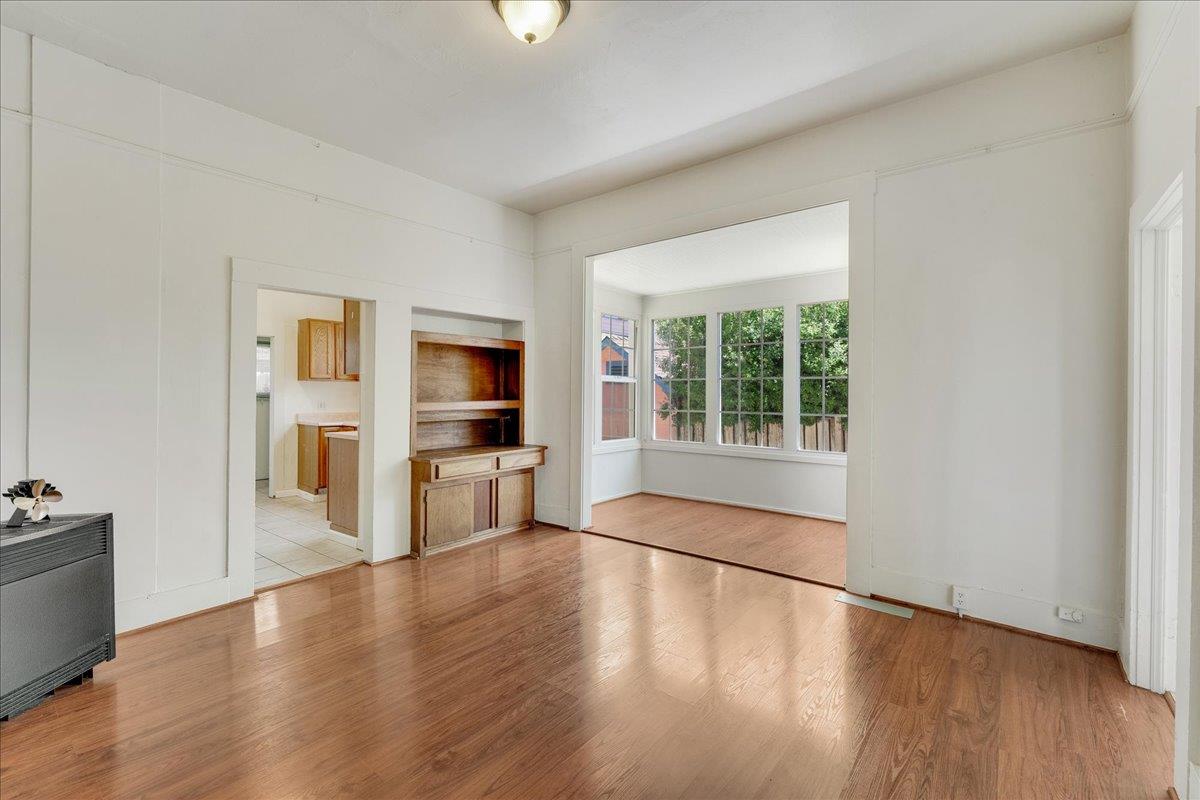 113 Fairbanks Street Santa Cruz, CA 95060 - Photo 10 of 27 wooden floor in an empty room with a kitchen