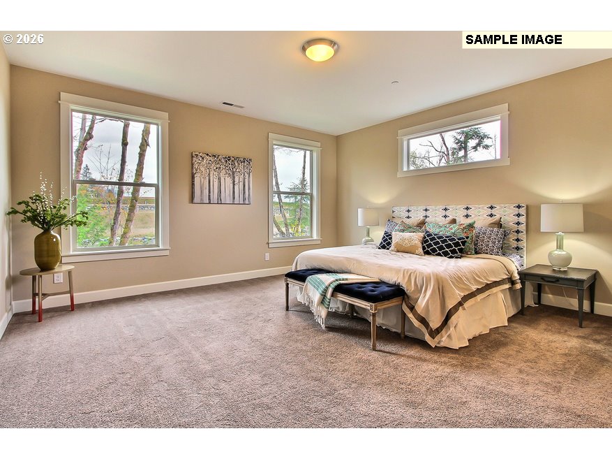 16997 Southwest Parrett Mountain Road Sherwood, OR 97140 - Photo 11 of 15 a spacious bedroom with a bed and a table