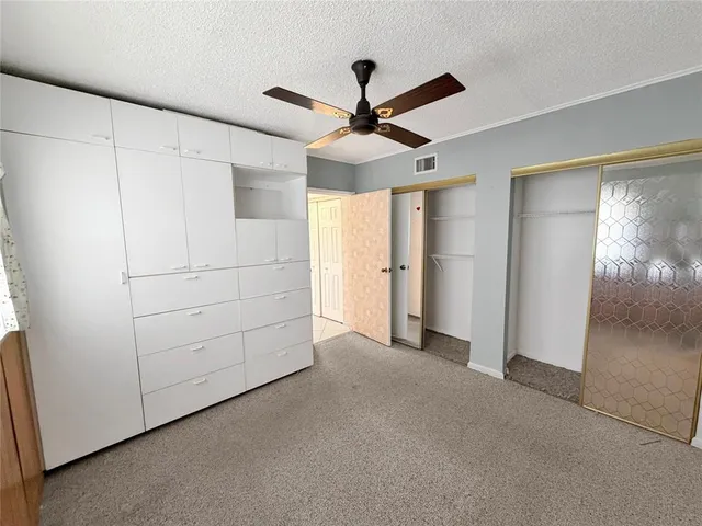 a view of a livingroom with an empty space and a ceiling fan