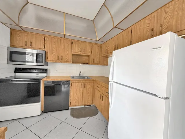 a kitchen with a refrigerator sink and microwave