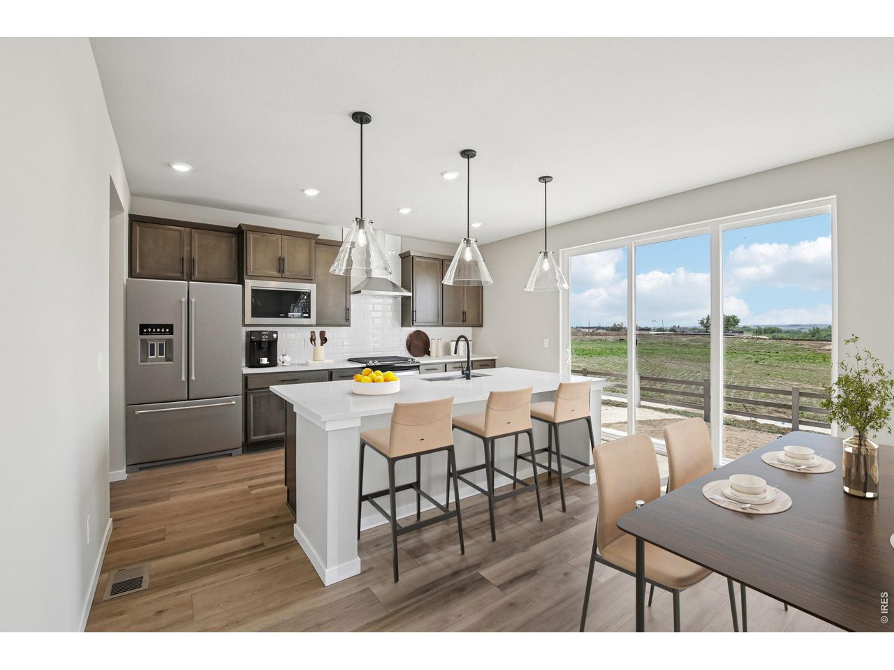 364 Rustic Barn Lane Berthoud, CO 80513 - Photo 10 of 50 a dining room with stainless steel appliances kitchen island granite countertop a table chairs and a view of living room