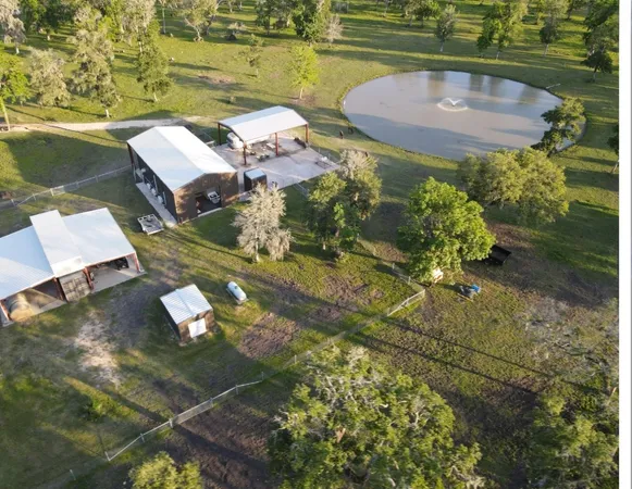an aerial view of a house with outdoor space