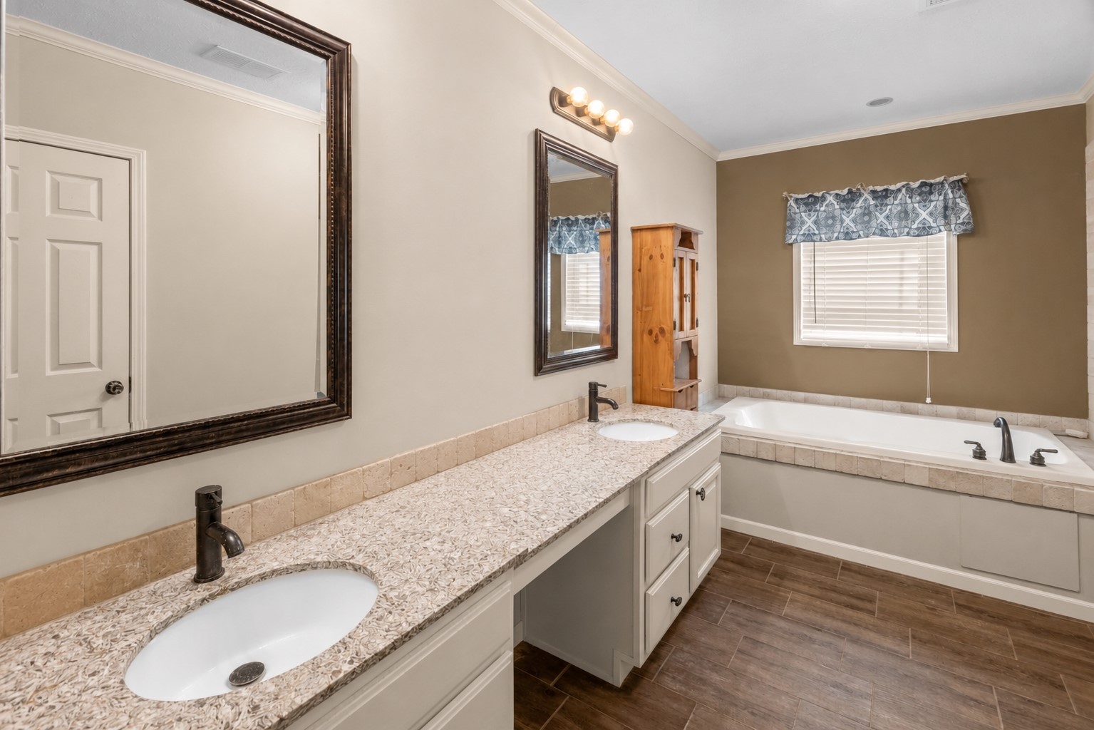 1800 2110th Road Hugo, OK 74743 - Photo 13 of 27 Dual vanity with granite-style countertop, undermount sinks, and dark-finish fixtures