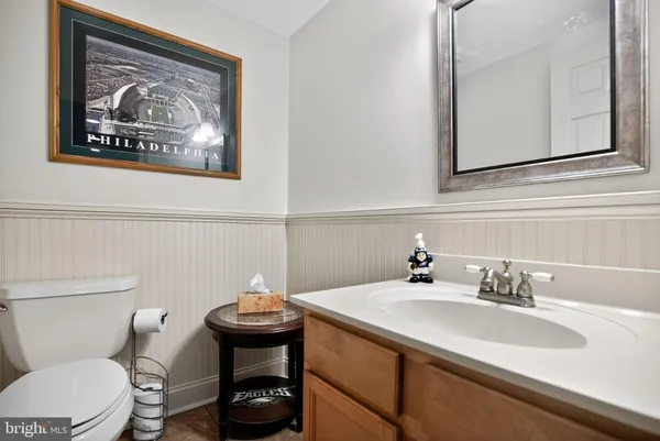 a bathroom with a toilet a sink and mirror