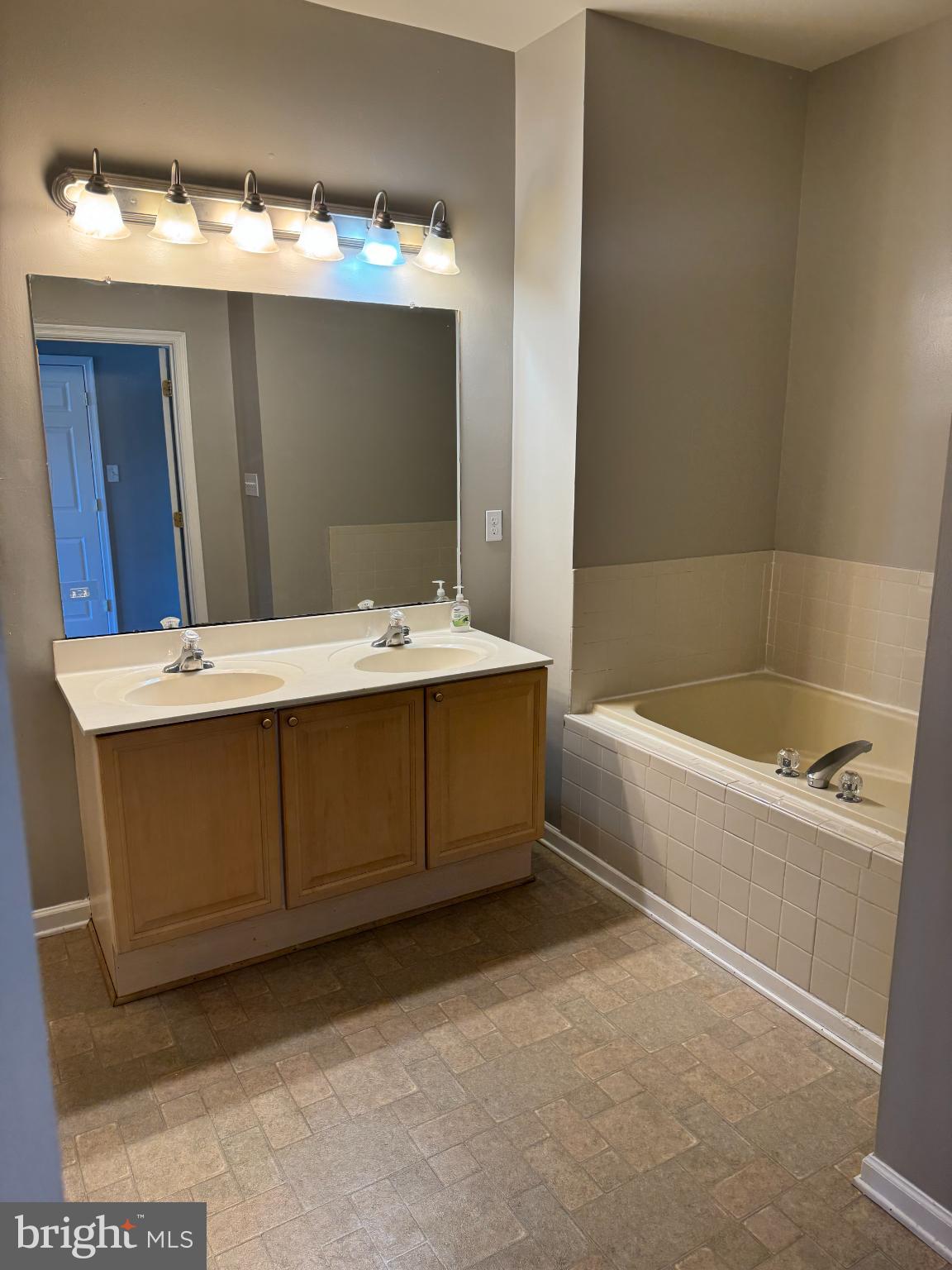39 Sagewood Street Charles Town, WV 25414 - Photo 16 of 19 a bathroom with a tub sink and mirror