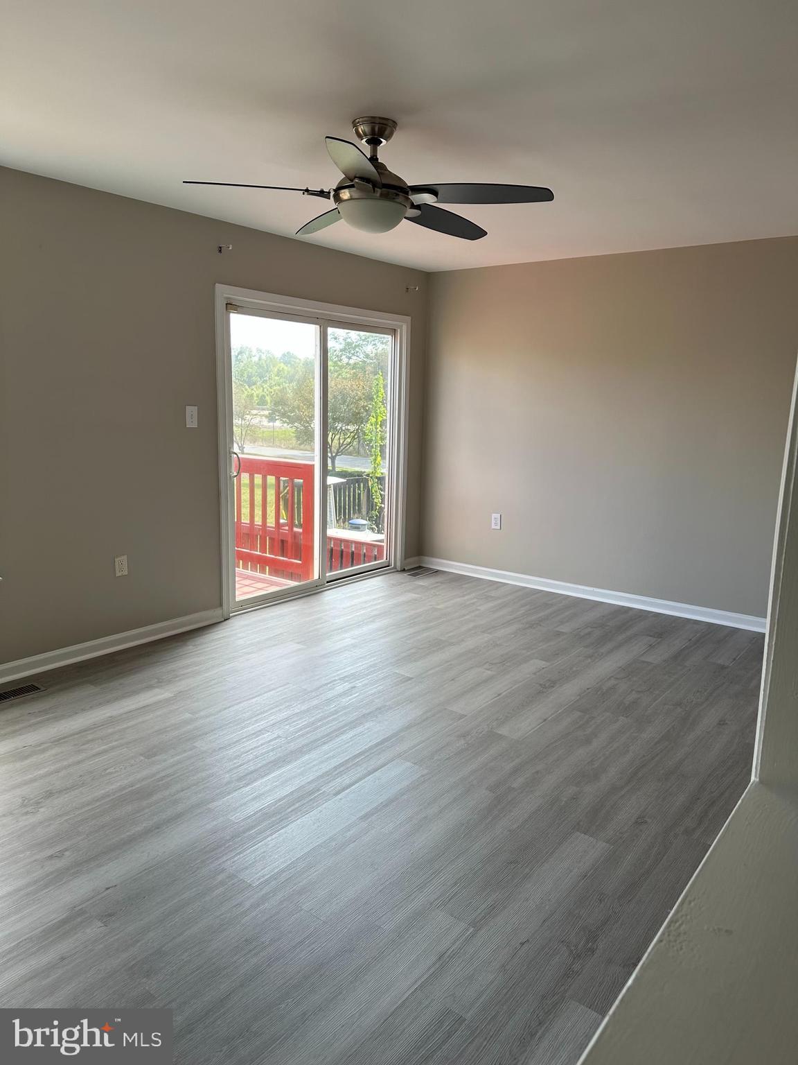 39 Sagewood Street Charles Town, WV 25414 - Photo 5 of 19 a view of an empty room with wooden floor and a window