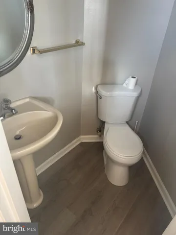 a white toilet sitting next to a bathroom sink