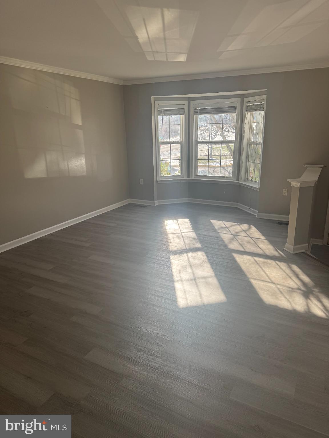 39 Sagewood Street Charles Town, WV 25414 - Photo 8 of 19 an empty room with wooden floor and windows
