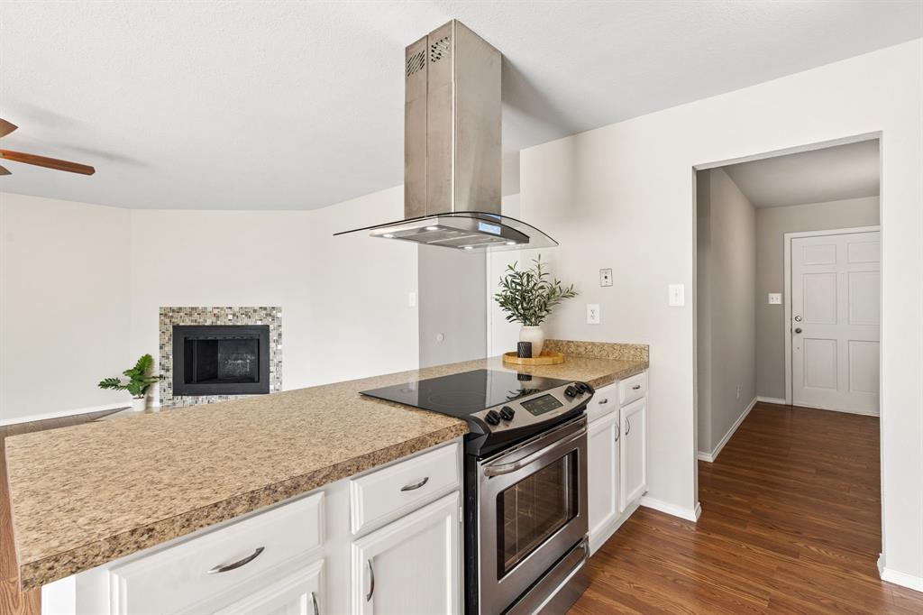 5620 Perrin Street The Colony, TX 75056 - Photo 11 of 31 a kitchen with granite countertop a stove and a sink