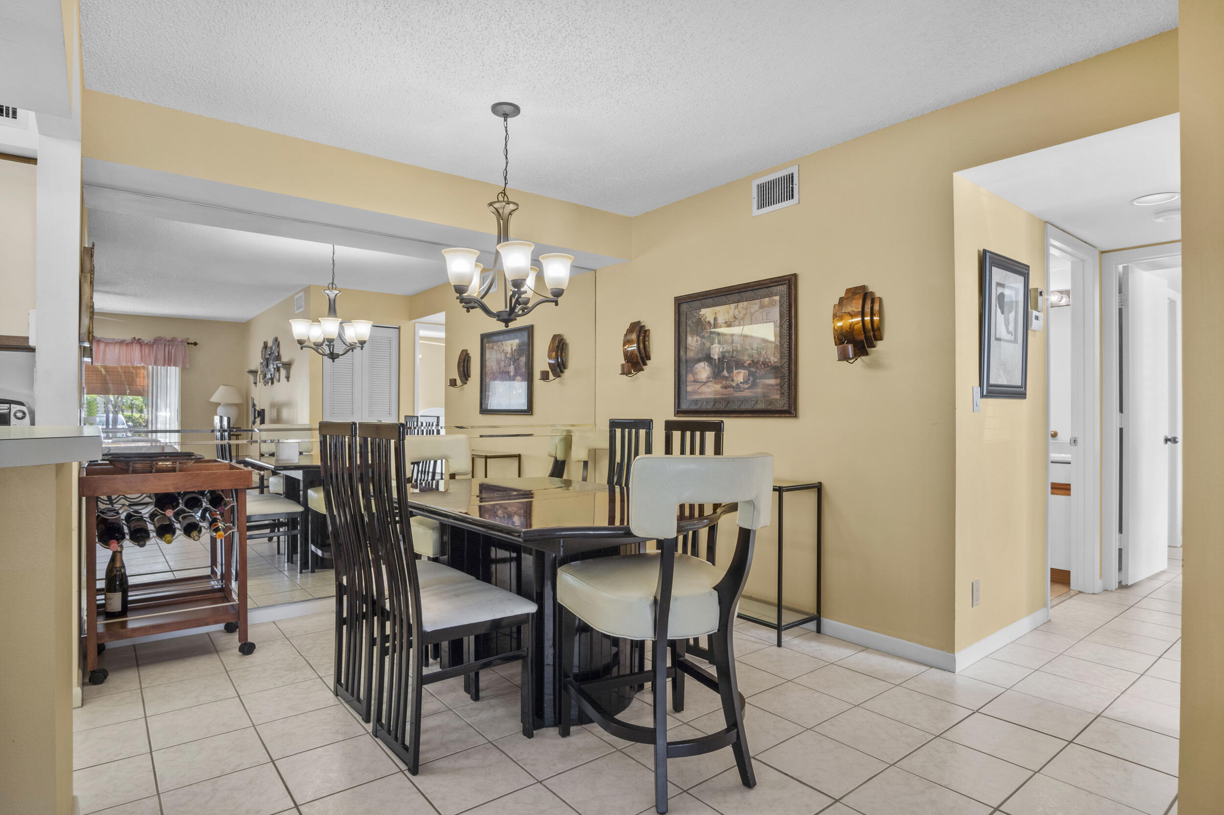 2512 Southeast Anchorage Cove, Unit B1 Port St. Lucie, FL 34952 - Photo 13 of 35 a view of a dining room with furniture and chandelier