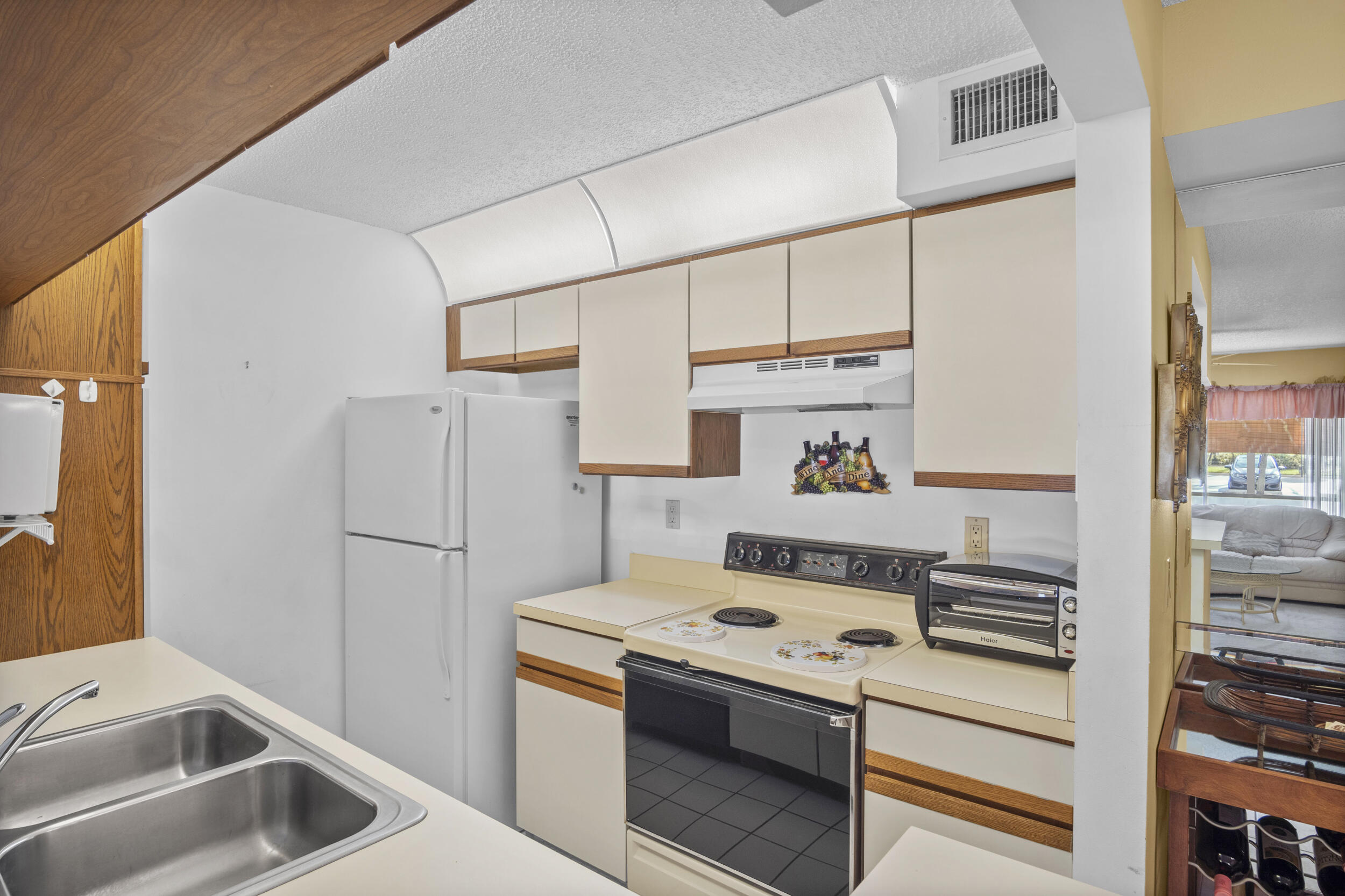 2512 Southeast Anchorage Cove, Unit B1 Port St. Lucie, FL 34952 - Photo 15 of 35 a kitchen with a white stove top oven and refrigerator