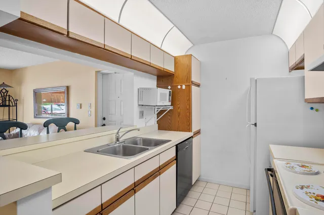 a kitchen with a sink and a refrigerator