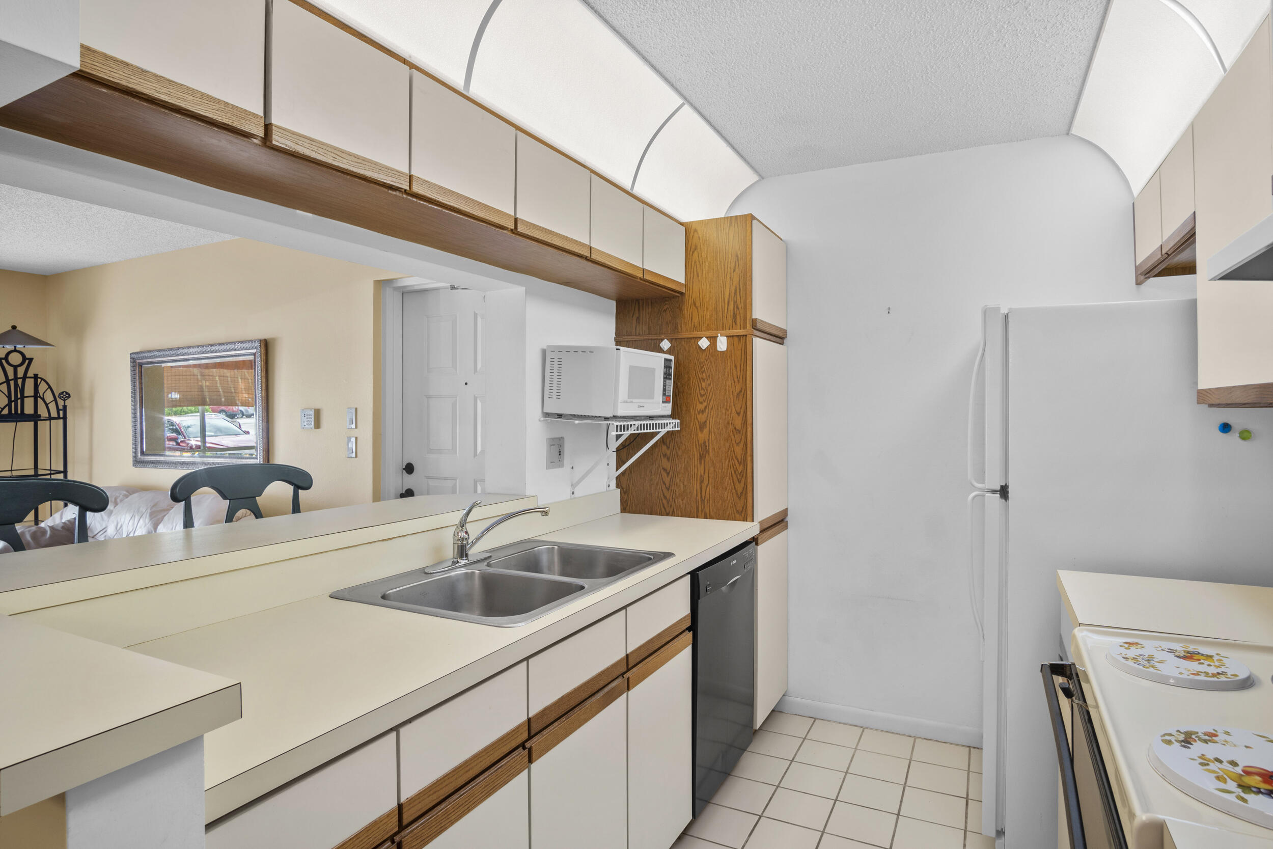 2512 Southeast Anchorage Cove, Unit B1 Port St. Lucie, FL 34952 - Photo 16 of 35 a kitchen with a sink and a refrigerator