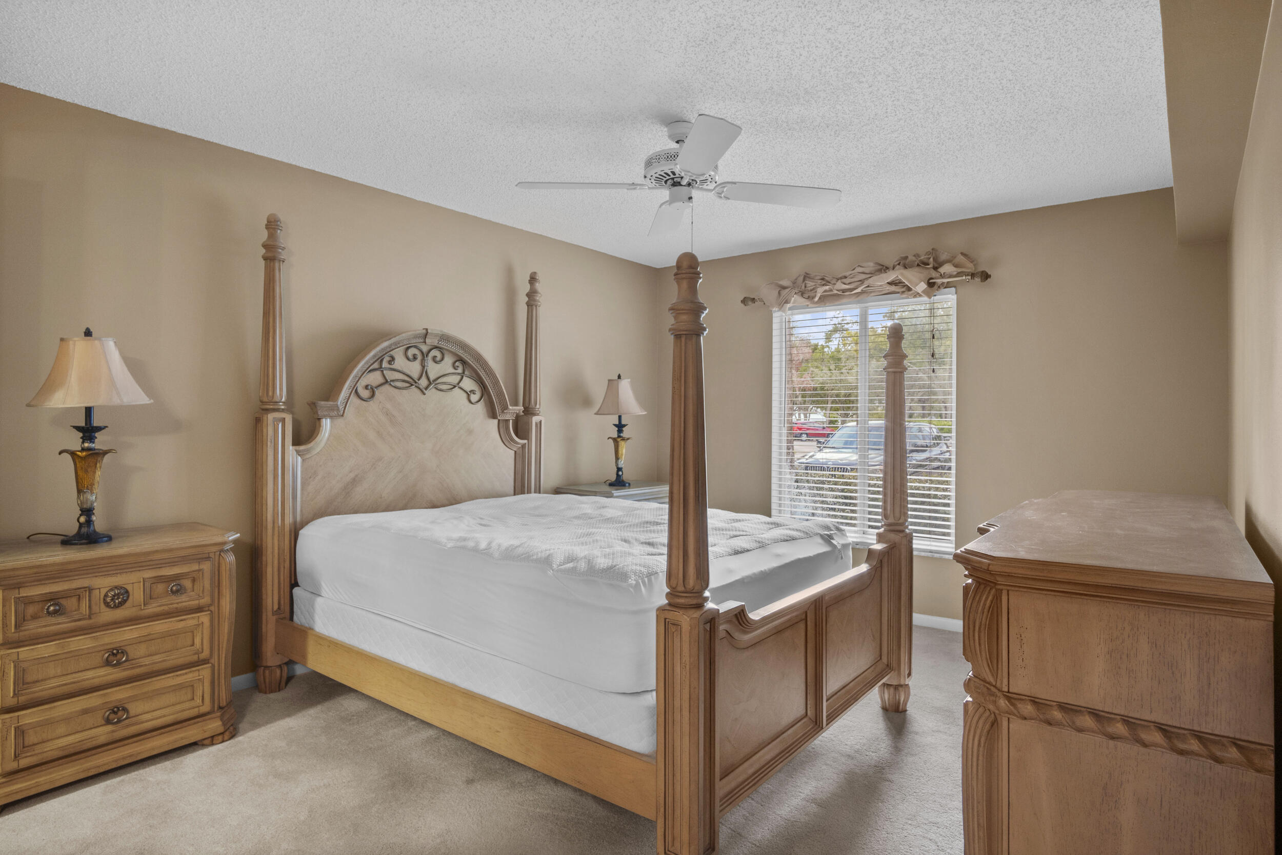 2512 Southeast Anchorage Cove, Unit B1 Port St. Lucie, FL 34952 - Photo 18 of 35 a bedroom with a bed and a chandelier