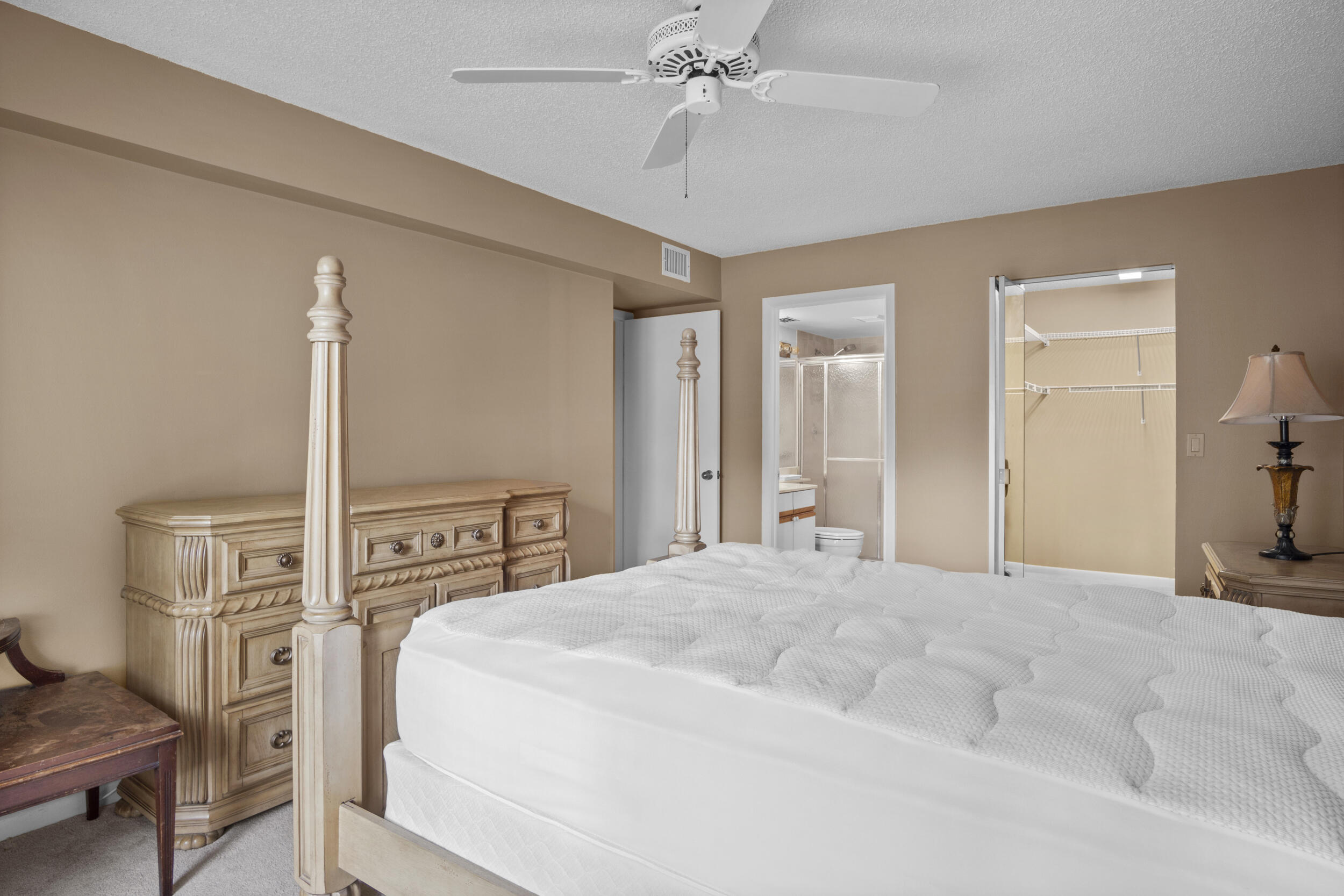 2512 Southeast Anchorage Cove, Unit B1 Port St. Lucie, FL 34952 - Photo 19 of 35 a bedroom with a bed and a chandelier