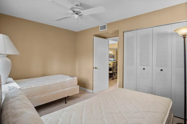 a bedroom with a bed closet and a lamp