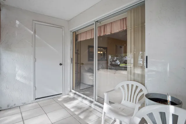 a view of a room that has a glass door and a glass door