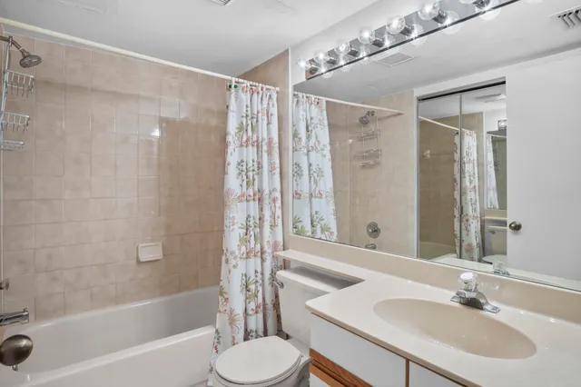 a bathroom with a sink toilet a shower and a mirror