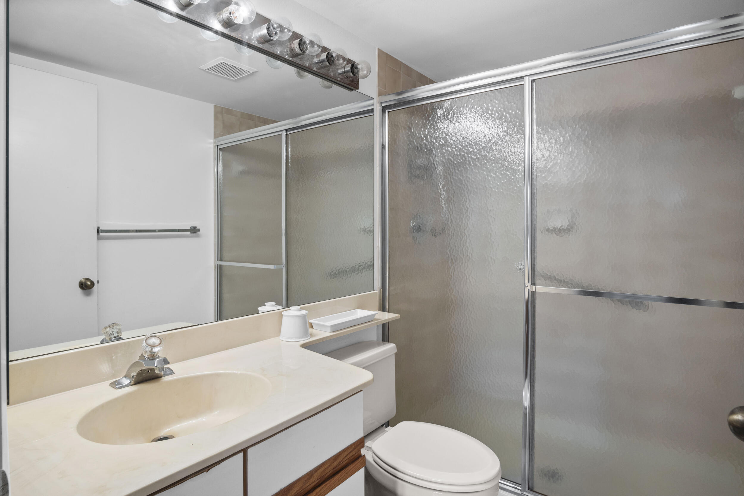 2512 Southeast Anchorage Cove, Unit B1 Port St. Lucie, FL 34952 - Photo 26 of 35 a bathroom with a sink toilet and shower