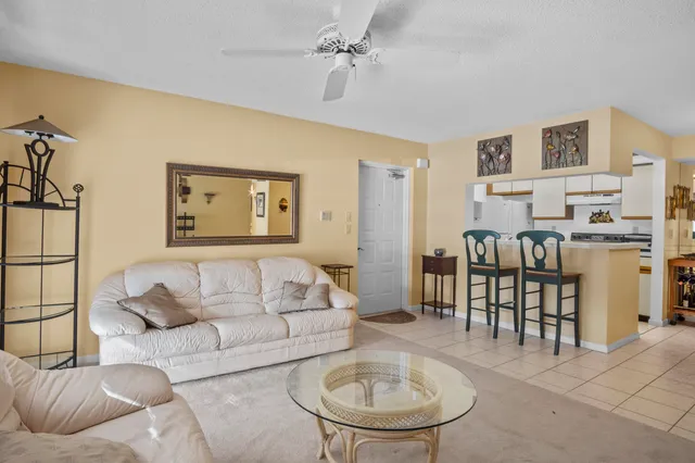 a living room with furniture and a dining table