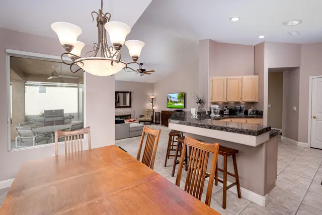 a large kitchen with a table and chairs
