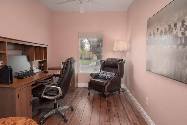 a view of workspace with wooden floor windows