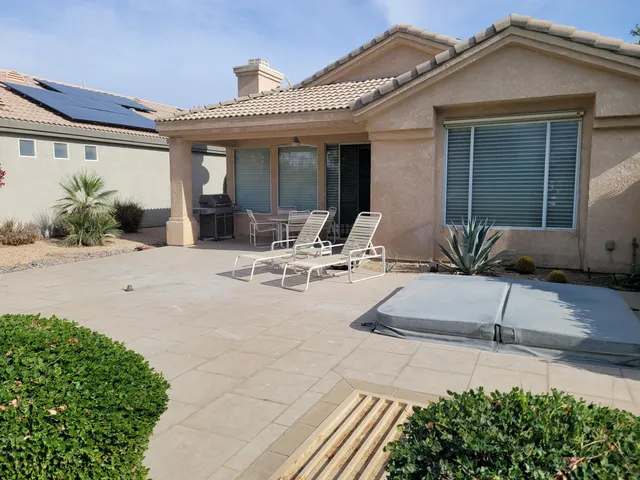 a view of a patio with table and chairs and potted plants