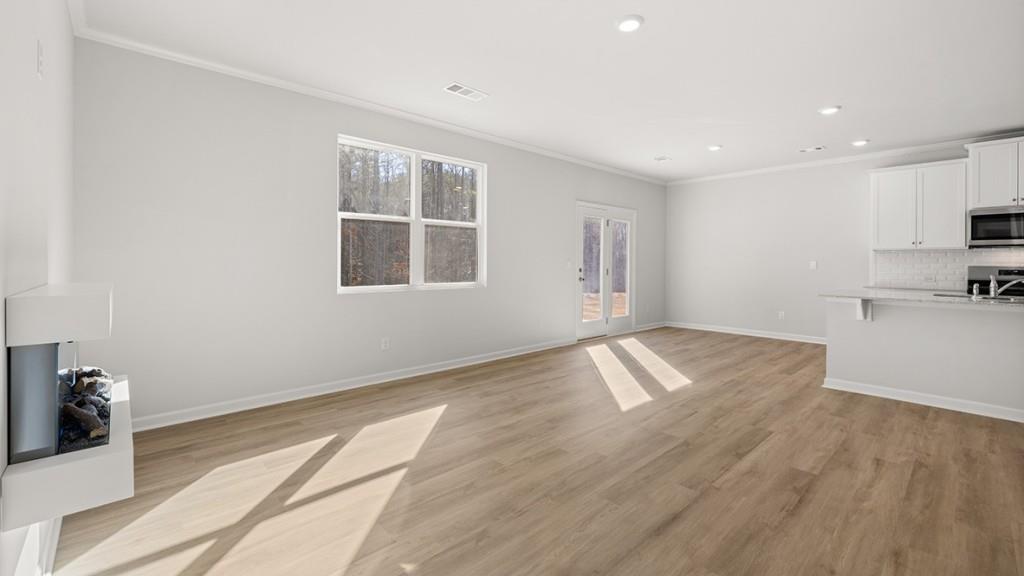 247 Hampton Terrace Dallas, GA 30157 - Photo 8 of 29 a view of empty room with wooden floor and kitchen view