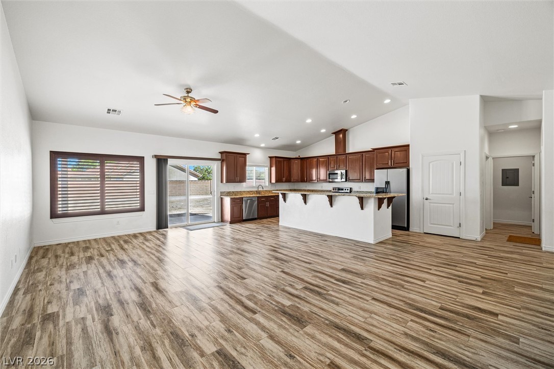 6720 Stubblefield Drive Pahrump, NV 89061 - Photo 8 of 51 An open concept living area offers rich wood look tile flooring and a modern kitchen with a breakfast bar.