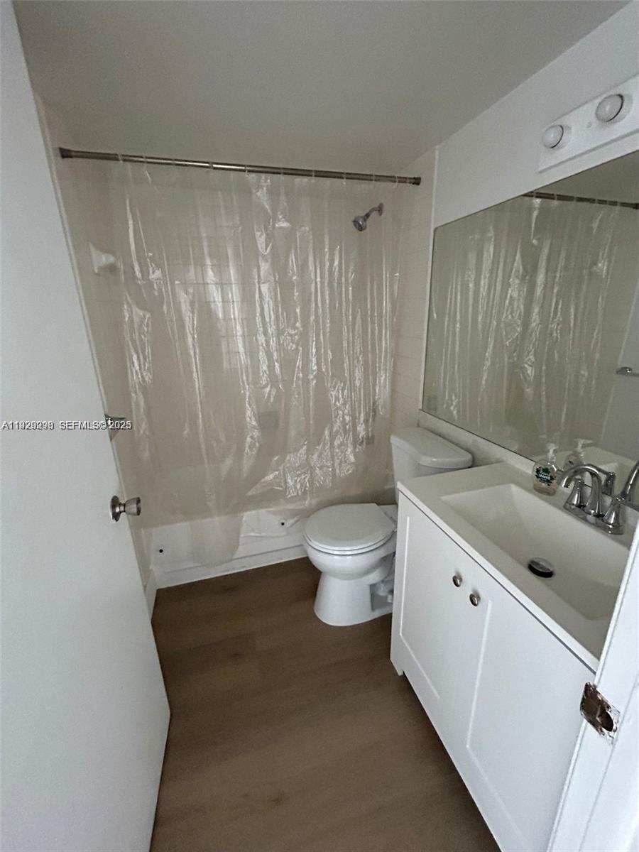 770 Claughton Island Drive, Unit 2109 Miami, FL 33131 - Photo 6 of 9 a bathroom with a double vanity sink toilet and shower