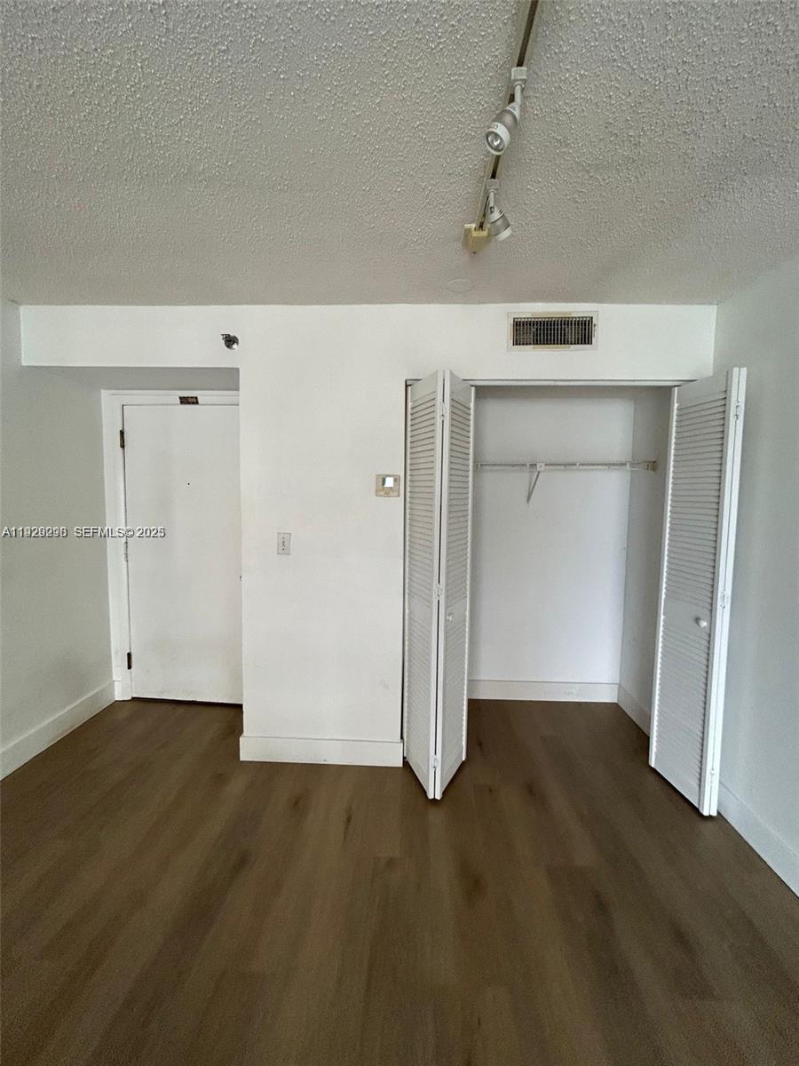 770 Claughton Island Drive, Unit 2109 Miami, FL 33131 - Photo 8 of 9 an empty room with wooden floor and window