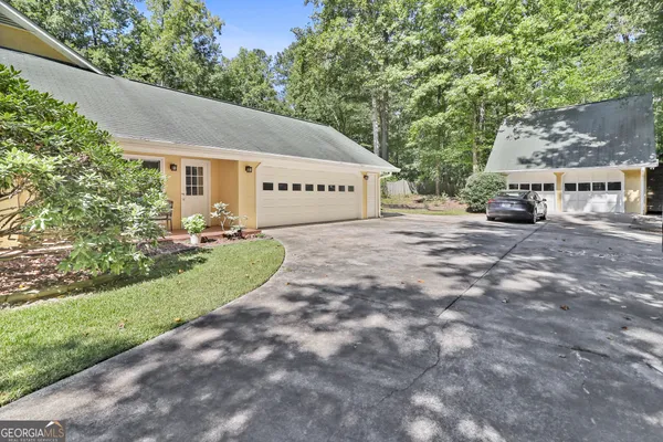 a view of a dining room with furniture a chandelier and wooden floor