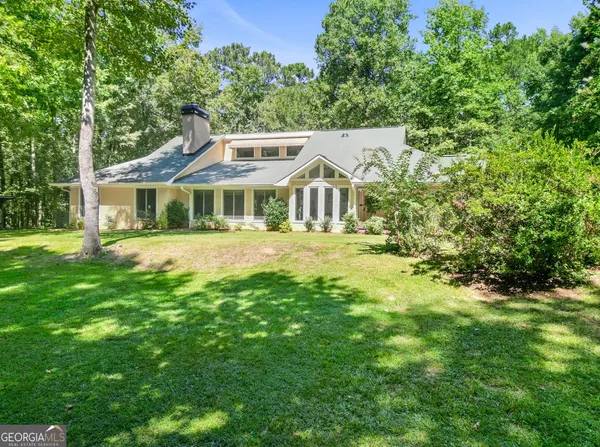 a kitchen with stainless steel appliances granite countertop a sink a stove and a wooden floors