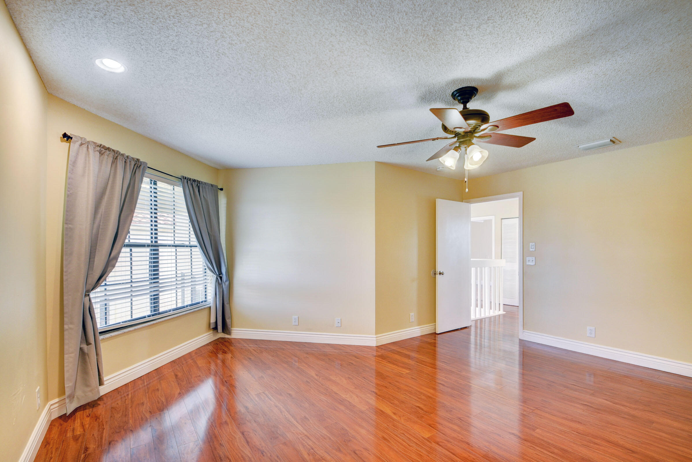 12561 Shoreside Lane Wellington, FL 33414 - Photo 23 of 31 wooden floor in an empty room with a window