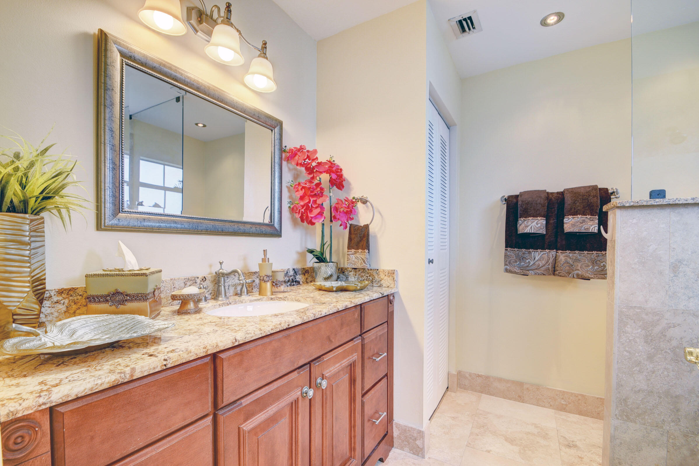 12561 Shoreside Lane Wellington, FL 33414 - Photo 24 of 31 a bathroom with a granite countertop double vanity sink and a mirror