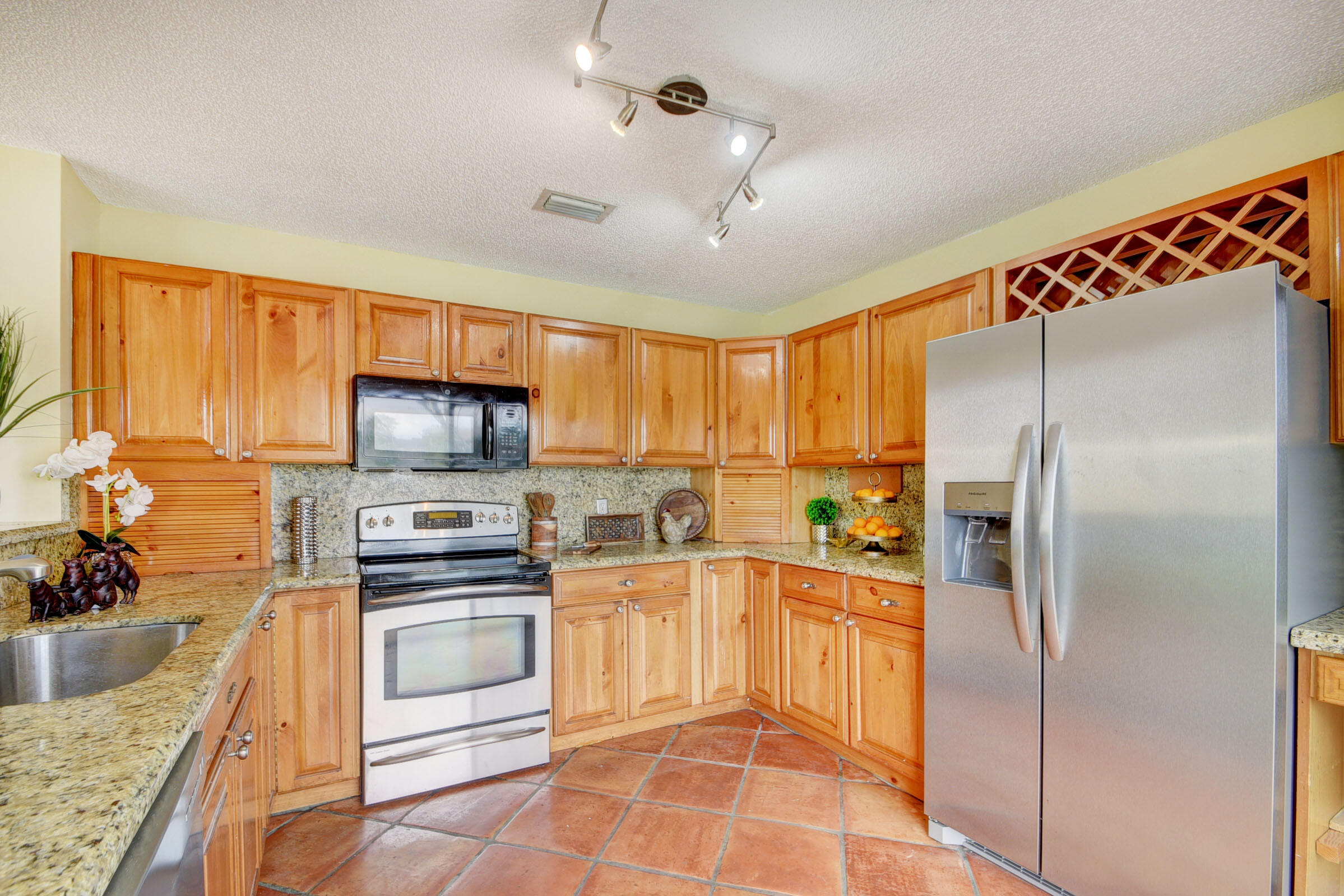 12561 Shoreside Lane Wellington, FL 33414 - Photo 3 of 31 a kitchen with stainless steel appliances a refrigerator sink and cabinets
