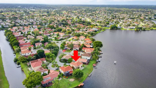an aerial view of residential houses with outdoor space and trees